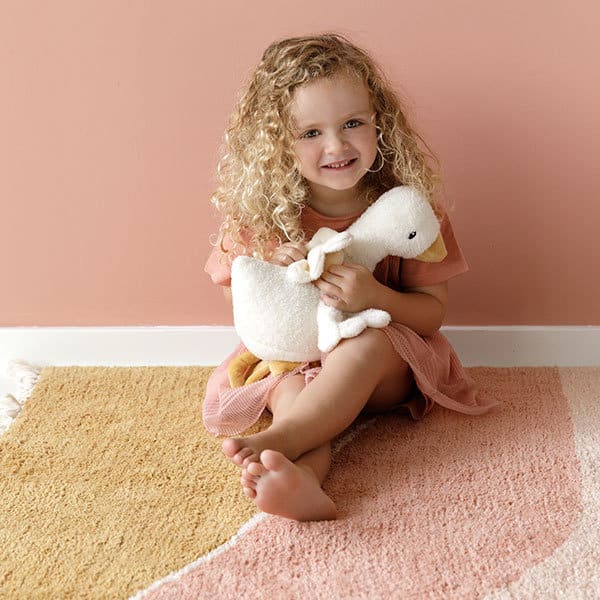 petite fille qui joue avec sa peluche oie